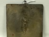 a metal object that is sitting on a white surface