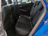 a blue car with a black seat cover and a black seat belt
