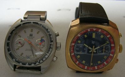 two watches sitting next to each other on a table