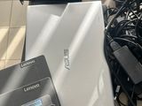 a lot of wires and cords on the floor next to a laptop