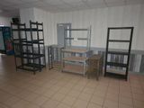 a room with shelves, shelves, and a desk in it