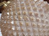 a glass bowl that is on a table in a cluttered room