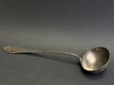 an old spoon with a spoon handle sitting on a table