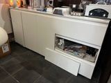 a kitchen with a microwave, coffee maker, and other items on the counter