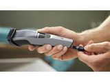 a person holding a hair clipper in their hand