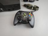 a video game controller sitting on a table next to a computer