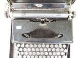 an old typewriter sitting on top of a table