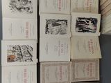 several books are stacked on top of each other on a table