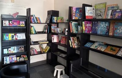 une bibliothèque noire remplie de livres dans une pièce