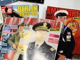 magazines on a table with a man in a military uniform on the cover