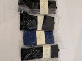 six pairs of black and blue socks sitting on top of a white surface