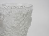 a glass vase with a white lace pattern on it