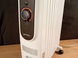 an image of a white electric heater on a wooden table