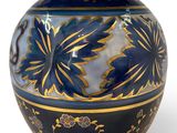 a blue and gold vase on a white background