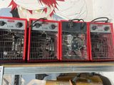 three red heaters on top of a shelf in a room