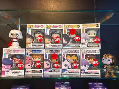 a lot of pop vinyl figures on display in a glass case