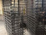 a large pile of wire baskets in a warehouse