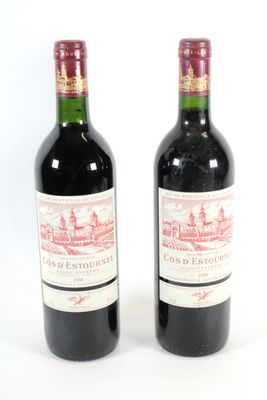 deux bouteilles de vin rouge posées l'une à côté de l'autre sur une surface blanche