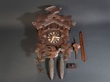 a clock that is hanging on the wall next to a pencil
