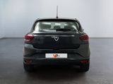 the back end of a black car in a room with a white wall