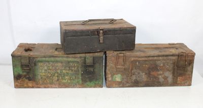 three old metal boxes stacked on top of each other on a white surface