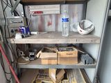 a shelf with boxes and tools on it in a garage