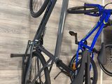 a bike hanging on the wall next to a pair of shoes