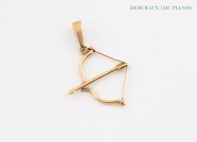 a gold bow and arrow pendant on a white background