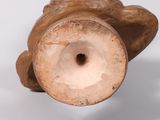 a brown vase sitting on a table with a white background