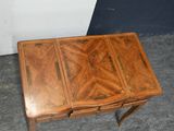 a small wooden table with a drawer on top of it