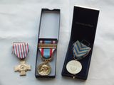 two medals and a medal in a box on a table