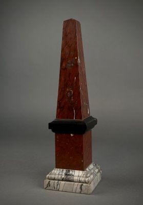 marble obelisk with a black base and a marble base