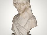 a white marble bust of a woman with a turban on her head