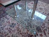 a glass table with a glass top on a rug