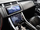 the interior of a car with a touch screen and steering controls