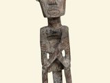 an image of a wooden sculpture of a man with a face