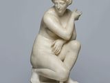 marble statue of a woman kneeling on a marble base