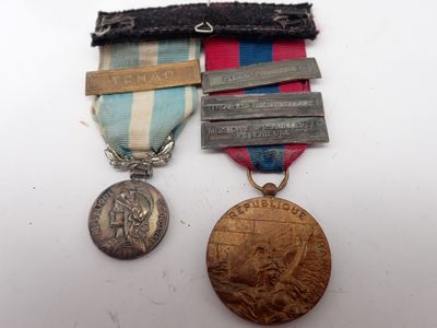 two medals and a medal on a white surface