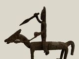 statue of a man riding a horse with a spear on its back
