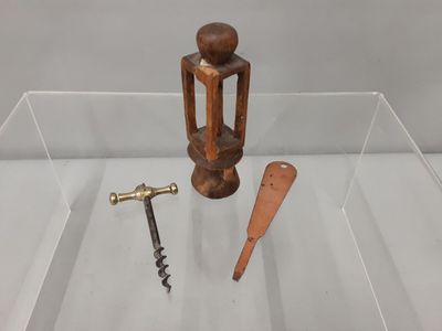 une vitrine en verre contenant un décapsuleur et un tire-bouchon
