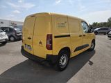 a yellow van that is parked in a parking lot