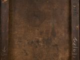 an old wooden frame with writing on it sitting on top of a table