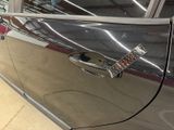 a silver car with a remote control on the door handle