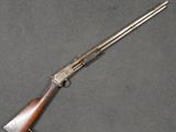 a rifle with a wooden barrel and a wooden handle