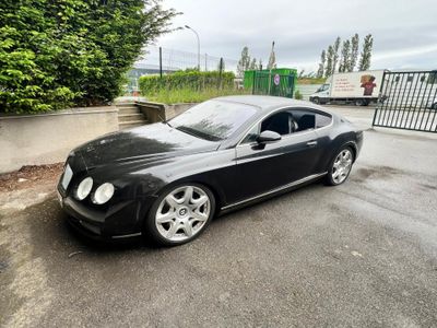 a picture of a black bentley car parked in a parking lot