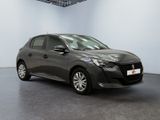 the grey car is parked in a large room with a black floor