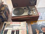 a record player sitting on top of a table next to a record player