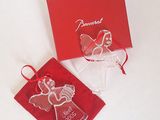 a red box with a glass angel ornament on it