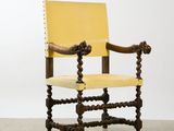 an image of a yellow leather chair with a wooden frame and wooden legs
