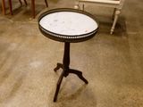 a small table with a marble top on a stand